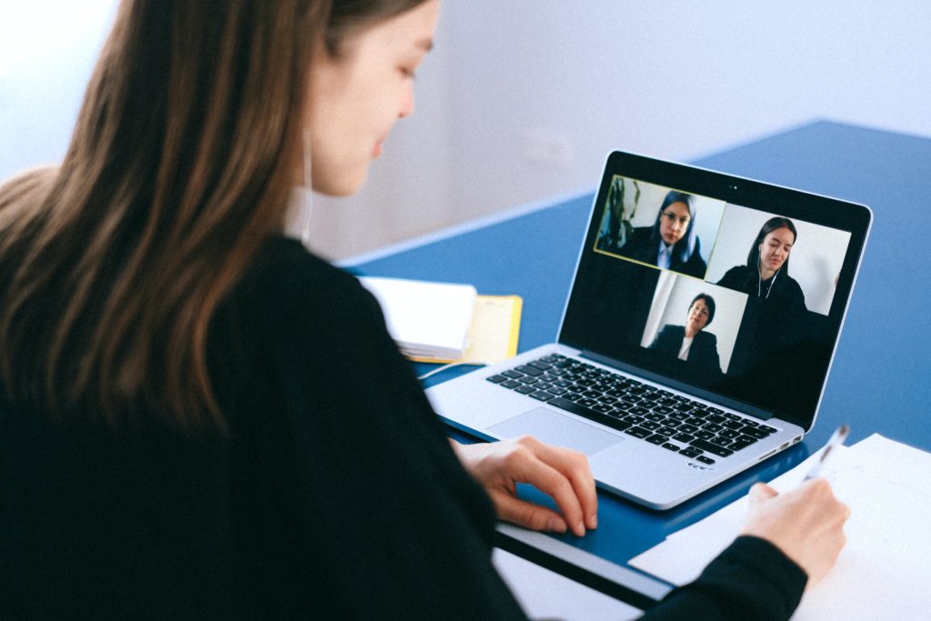 woman working remotely with laptop on video conference call